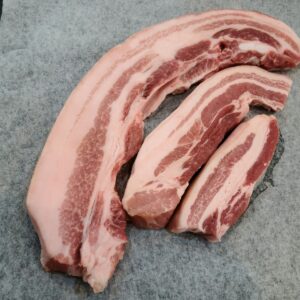 a pile of raw meat sitting on top of a cutting board